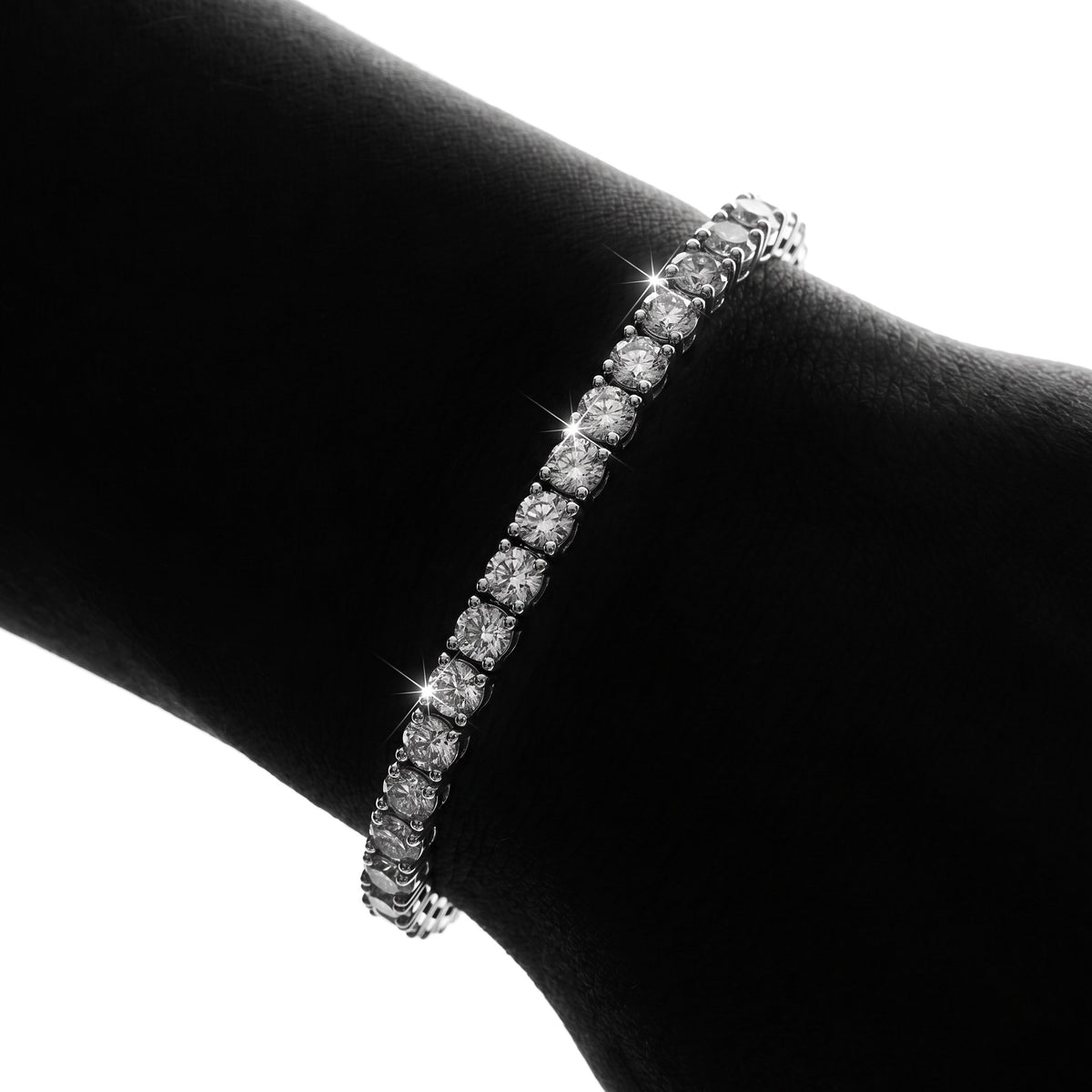Magnified close-up of lab-grown moissanite stones in four-prong settings on a wrist (illustrative render)